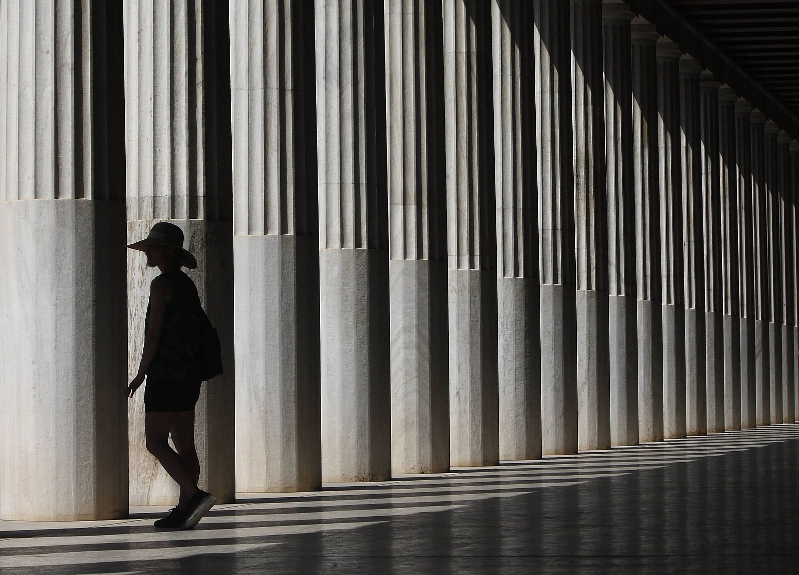 A tourist walks inside Attalos Arcade in the ancient agora in Athens