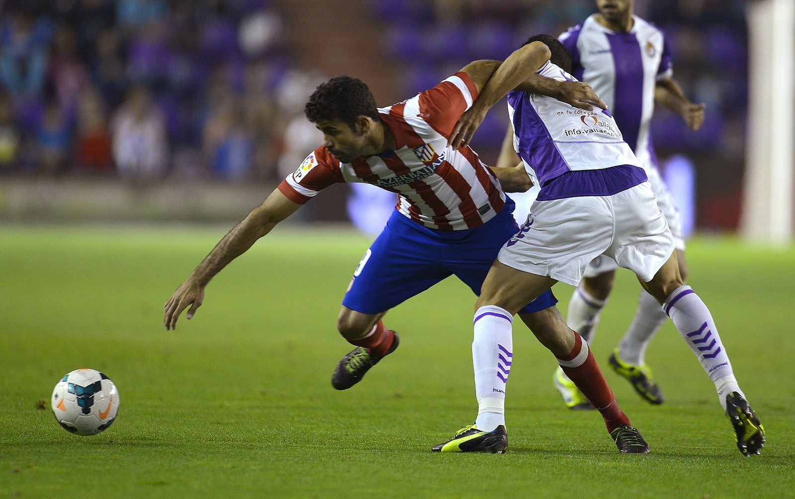 Atletico Madrid's Digo Costa fights for the ball with Valladolid's Pena during their Spanish First Division soccer match at Zorrilla Stadium in Valladolid