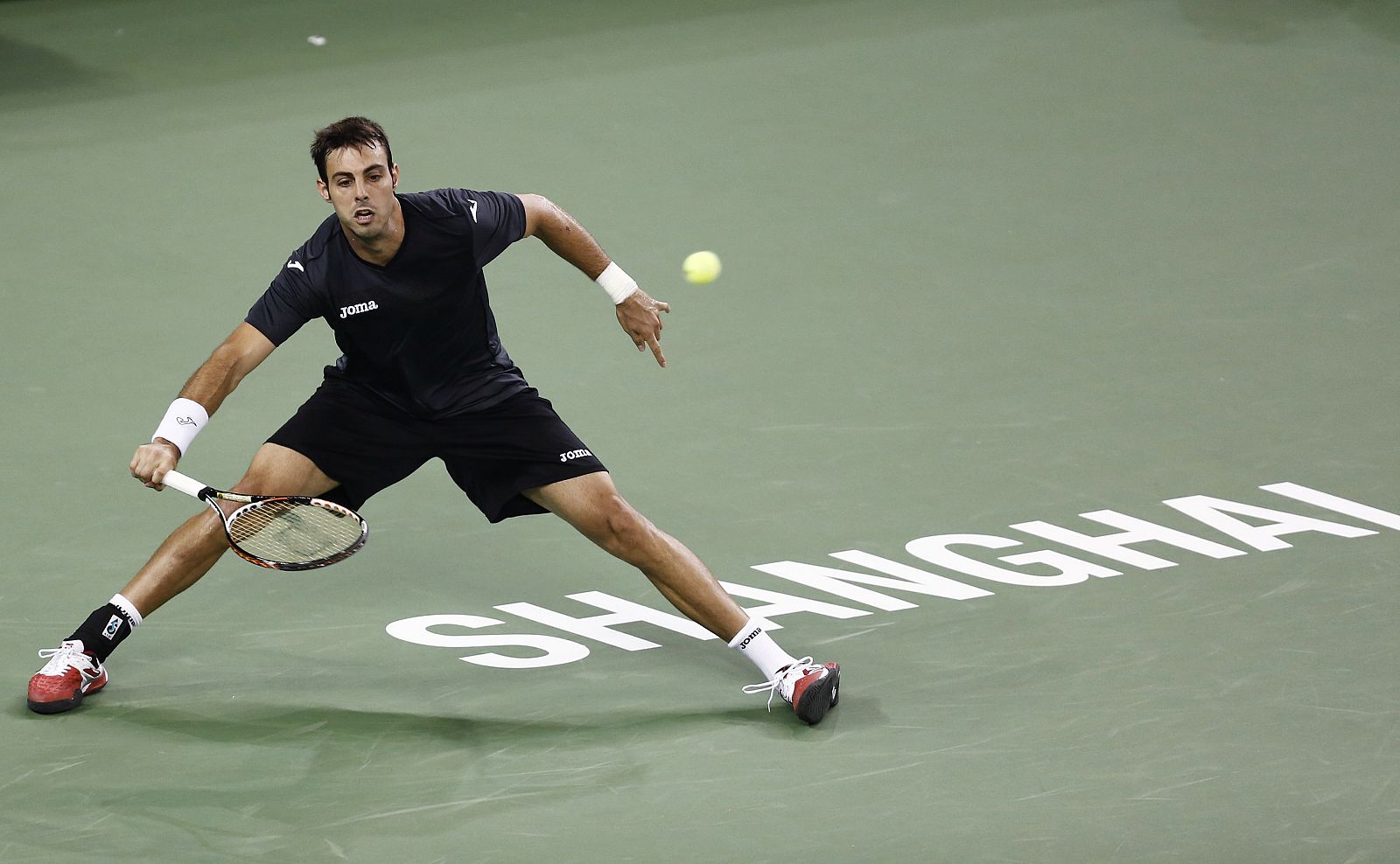 Granollers of Spain hits a shot against Tipsarevic of Serbia during their men's singles match at the Shanghai Masters tennis tournament