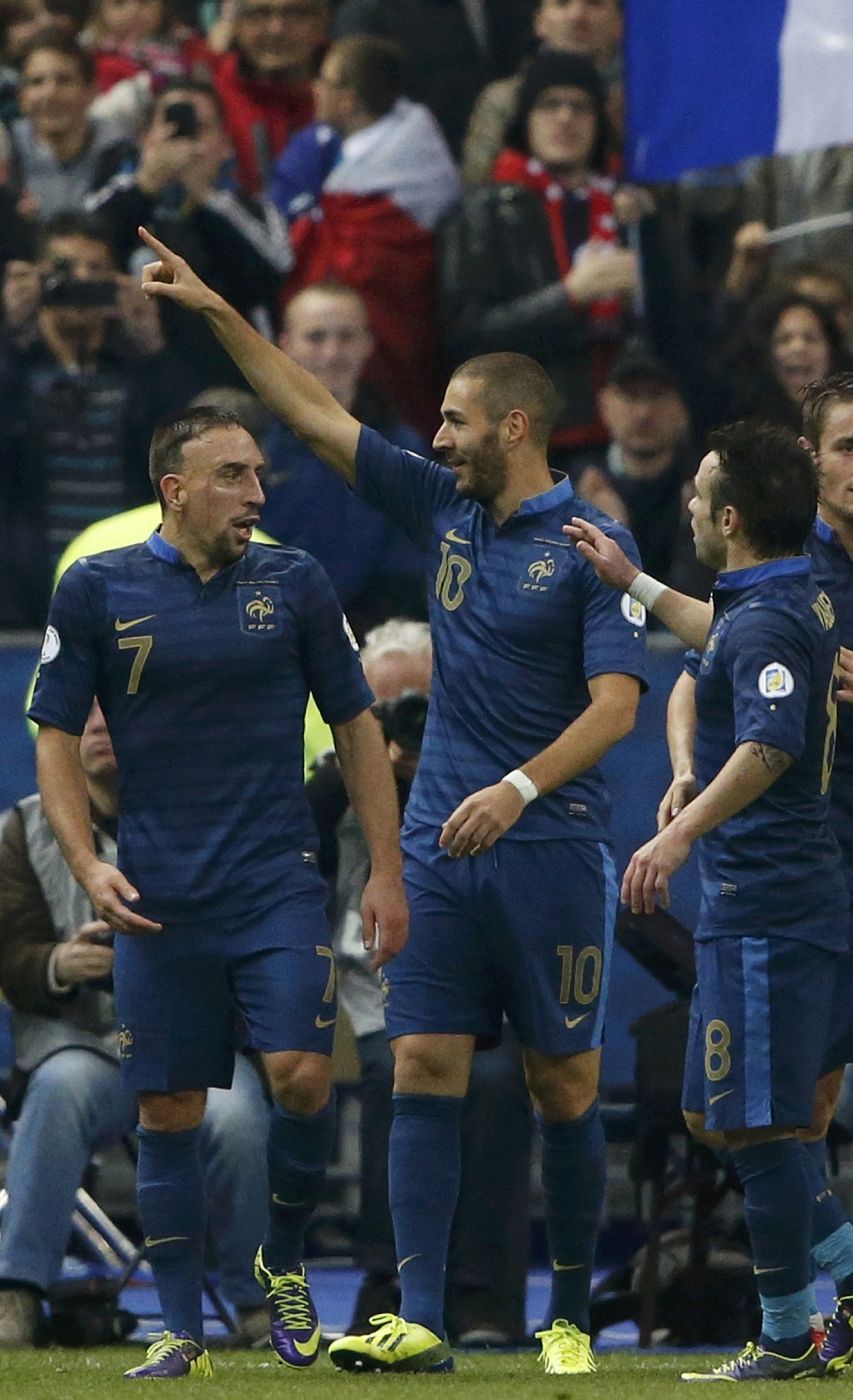 France's Benzema celebrates with team mates Ribery and Valbuena after he scored against Finland during their 2014 World Cup qualiying soccer match in Saint-Denis