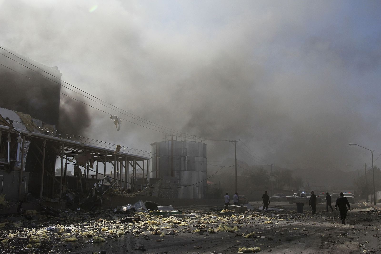 Police officers walk outside a candy factory after an explosion in Ciudad Juarez