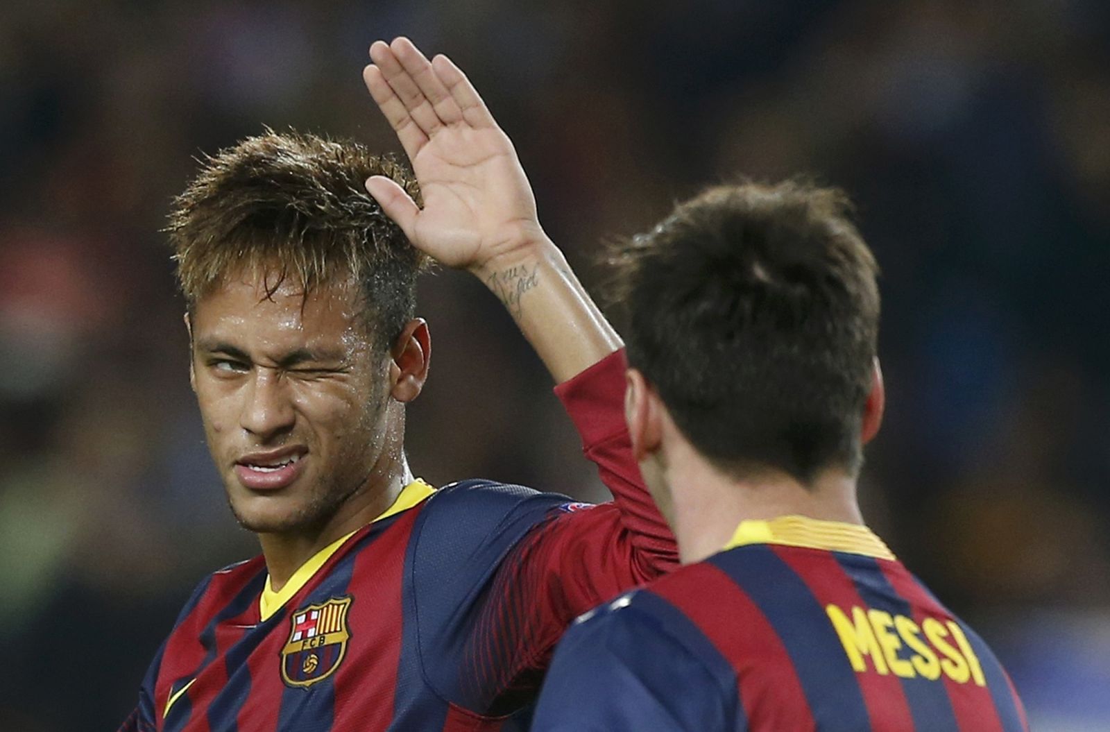 Barcelona's Neymar  winks his eye as he congratulates team mate Messi after scoring a penalty against AC Milan during their Champions League soccer match in Barcelona