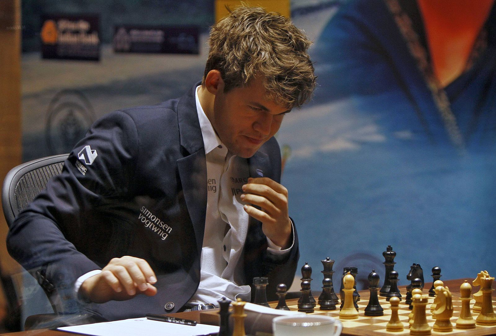 Norway's Carlsen writes down his move against India's Anand during the FIDE World Chess Championship in Chennai