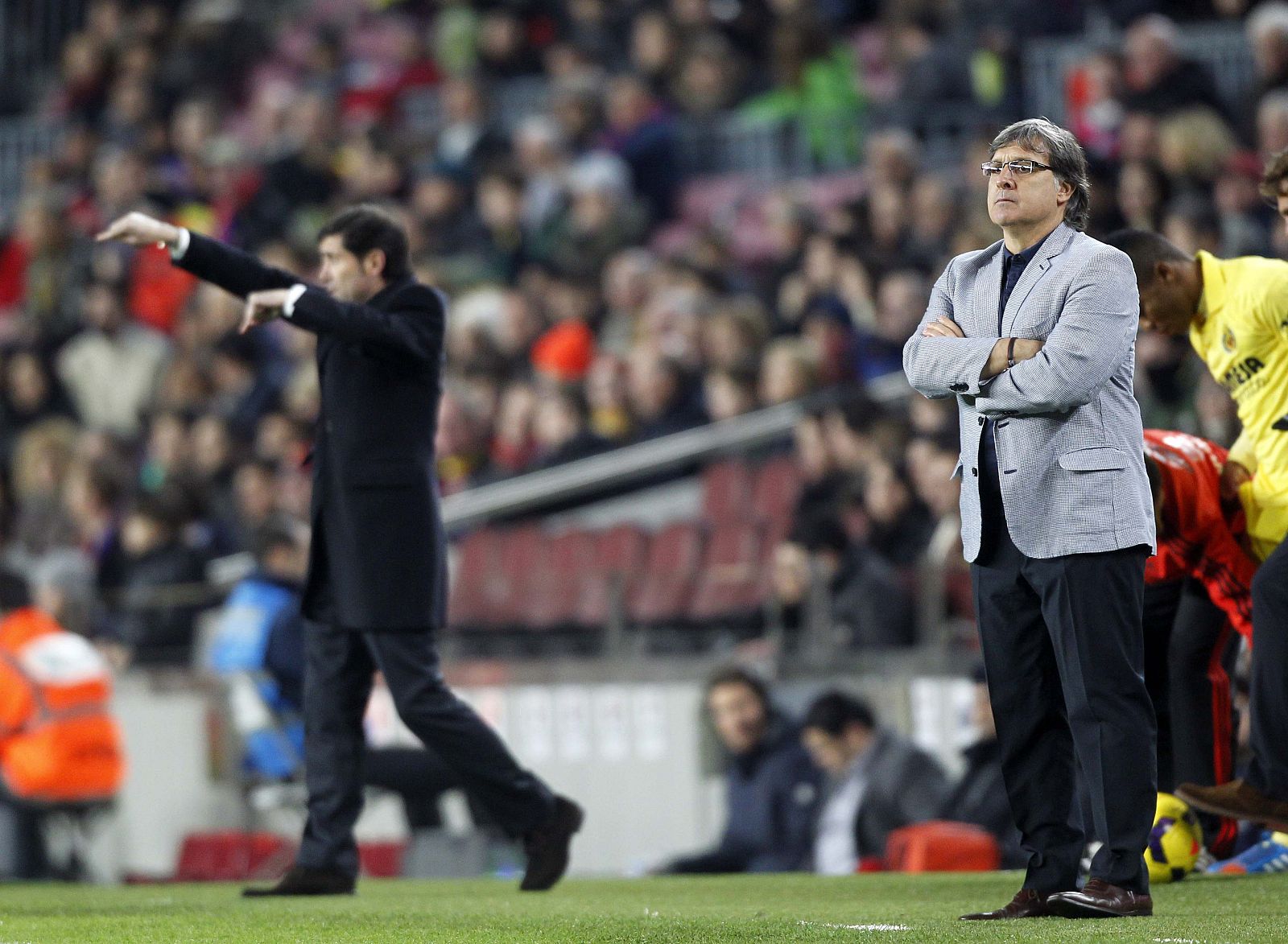 Barcelona's coach Martino looks at the pitch as Villarreal's coach Garcia gestures during their Spanish First division League soccer match at Camp Nou stadium in Barcelona