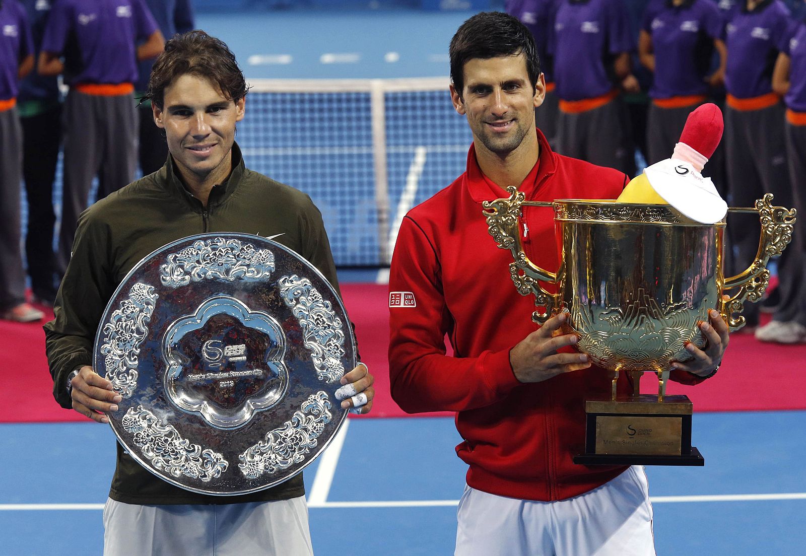 Spain's Rafael Nadal and Novak Djokovic of Serbia pose with their trophies after their men's singles final match in Beijing
