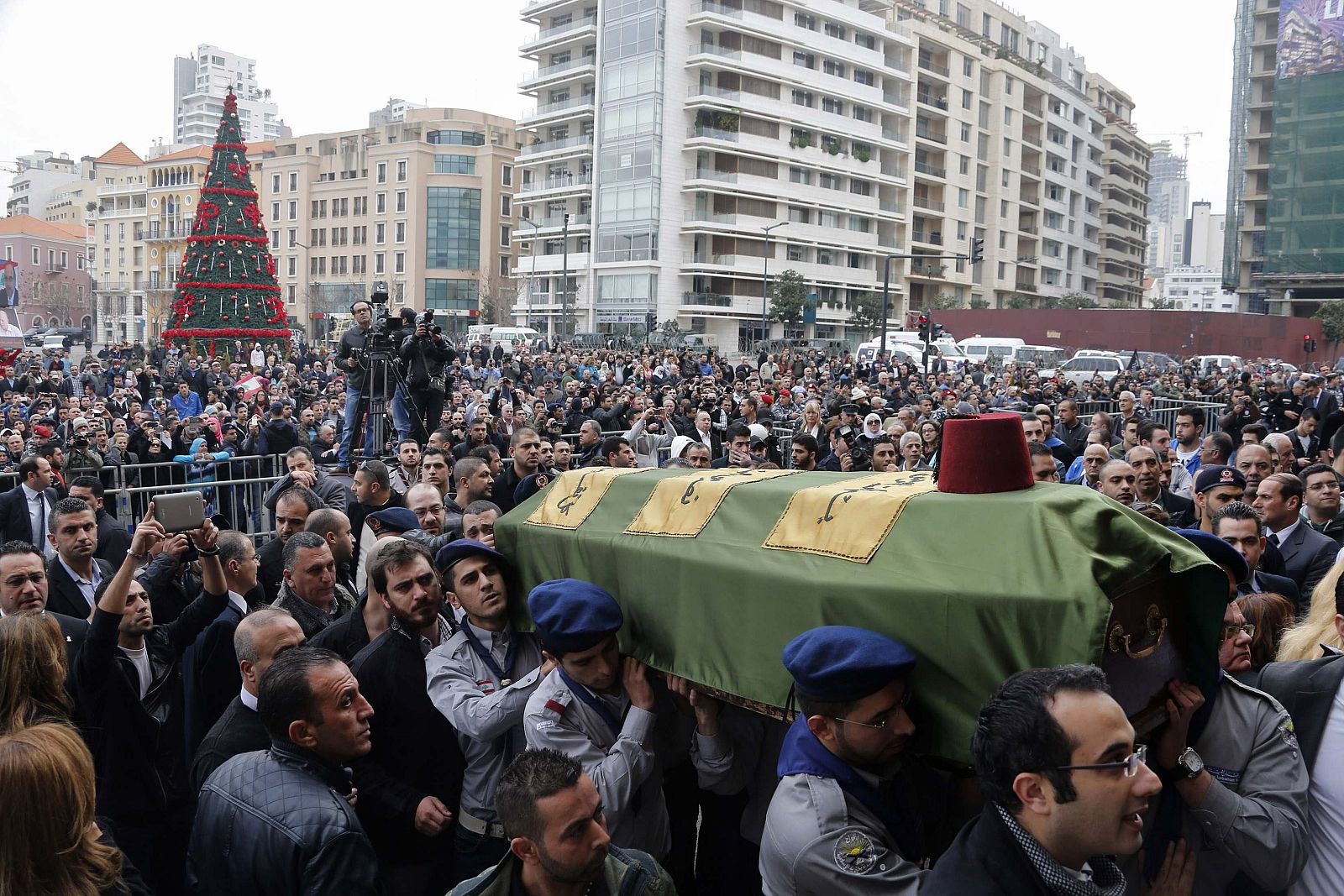 Scouts and relatives carry the coffin of former Lebanese minister Chatah, who was killed in a bomb blast on Friday, during his mass funeral at al-Amin mosque in Martyrs' Square in downtown Beirut