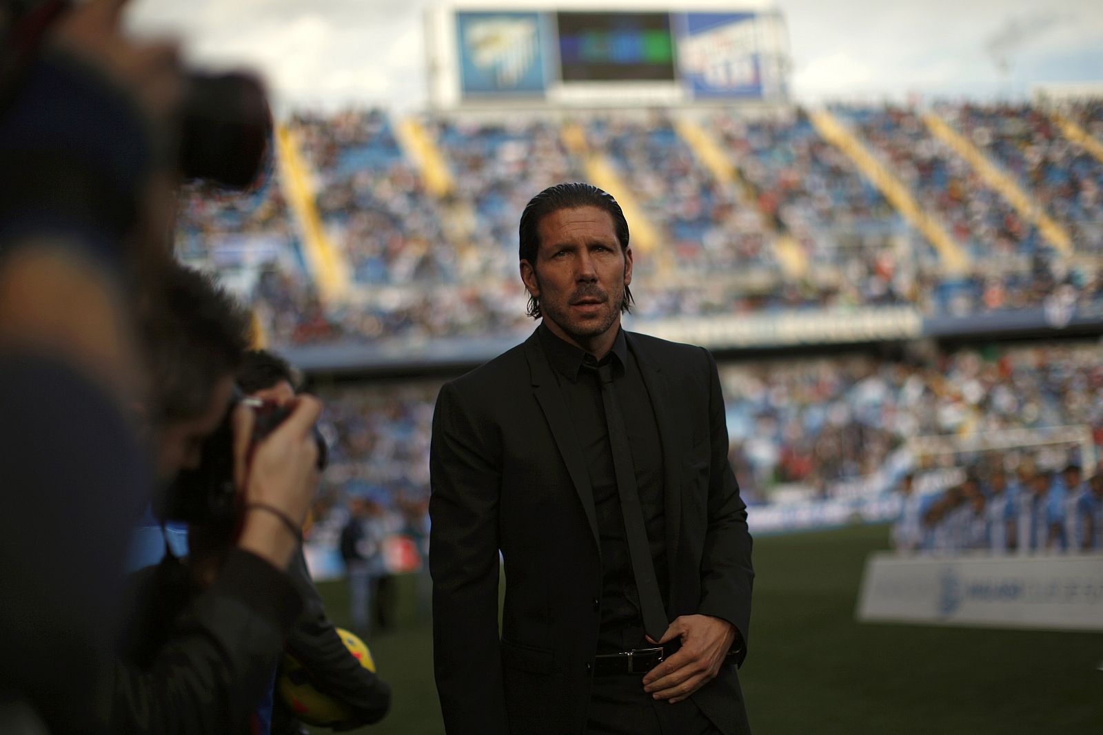 Atletico Madrid's coach Simeone walks to the bench before their Spanish First Division soccer match against Malaga in Malaga
