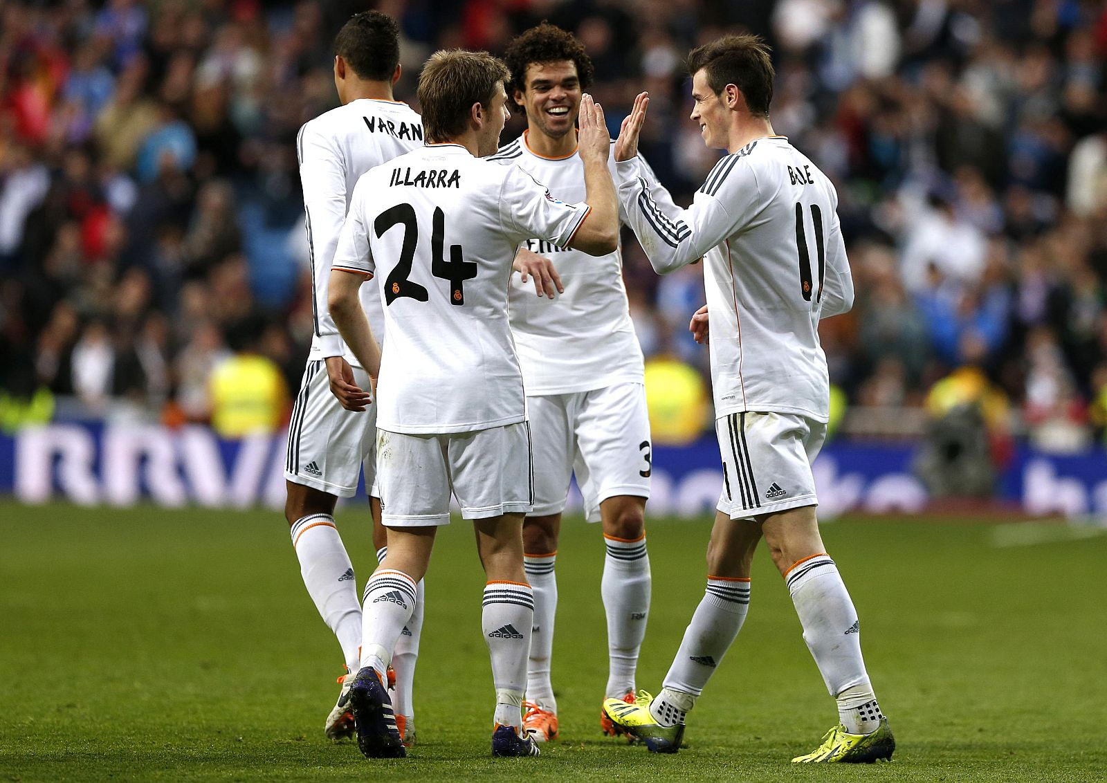 Real Madrid's Bale is congratulated by his teammates Illarramendi and Pepe after scoring during their Spanish first division soccer match against Elche in Madrid
