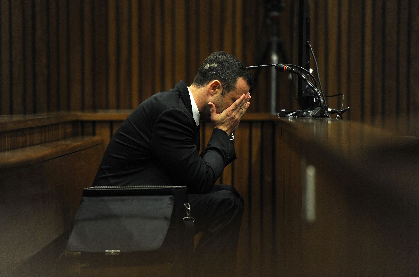 Olympic and Paralympic track star Oscar Pistorius reacts during the fourth day of his trial for the murder of his girlfriend Reeva Steenkamp at the North Gauteng High Court in Pretoria