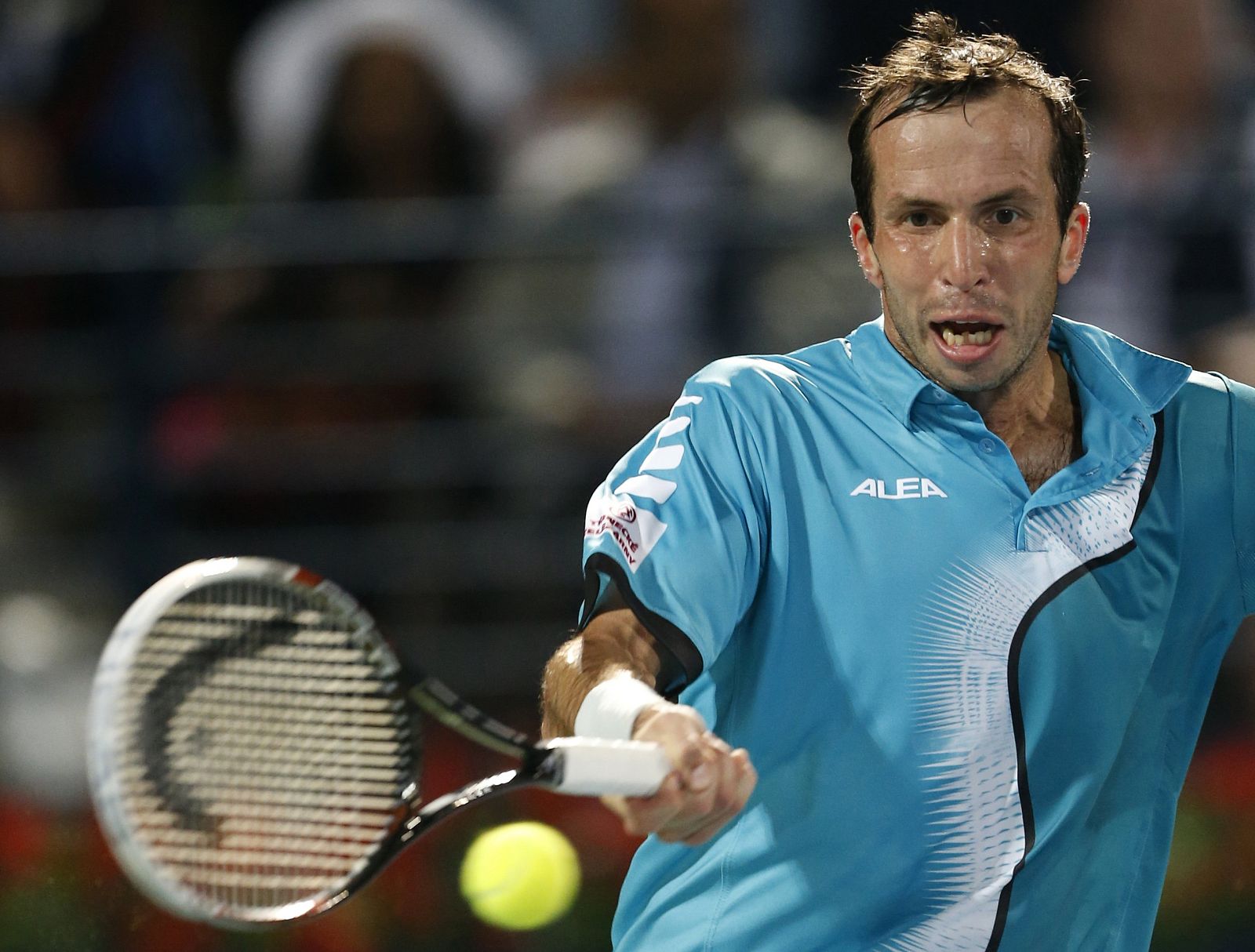 Radek Stepanek of Czech Republic returns the ball to Roger Federer of Switzerland during their men's singles match at the ATP Dubai Tennis Championships