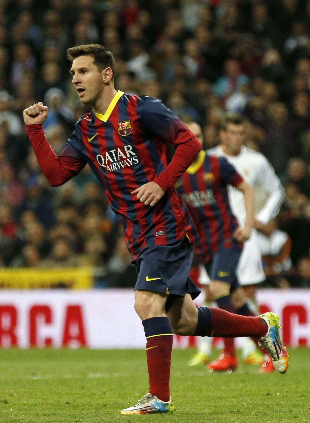 Barcelona's Lionel Messi celebrates after scoring a penalty against Real Madrid during La Liga's second 'Clasico' soccer match of the season at Santiago Bernabeu stadium in Madrid