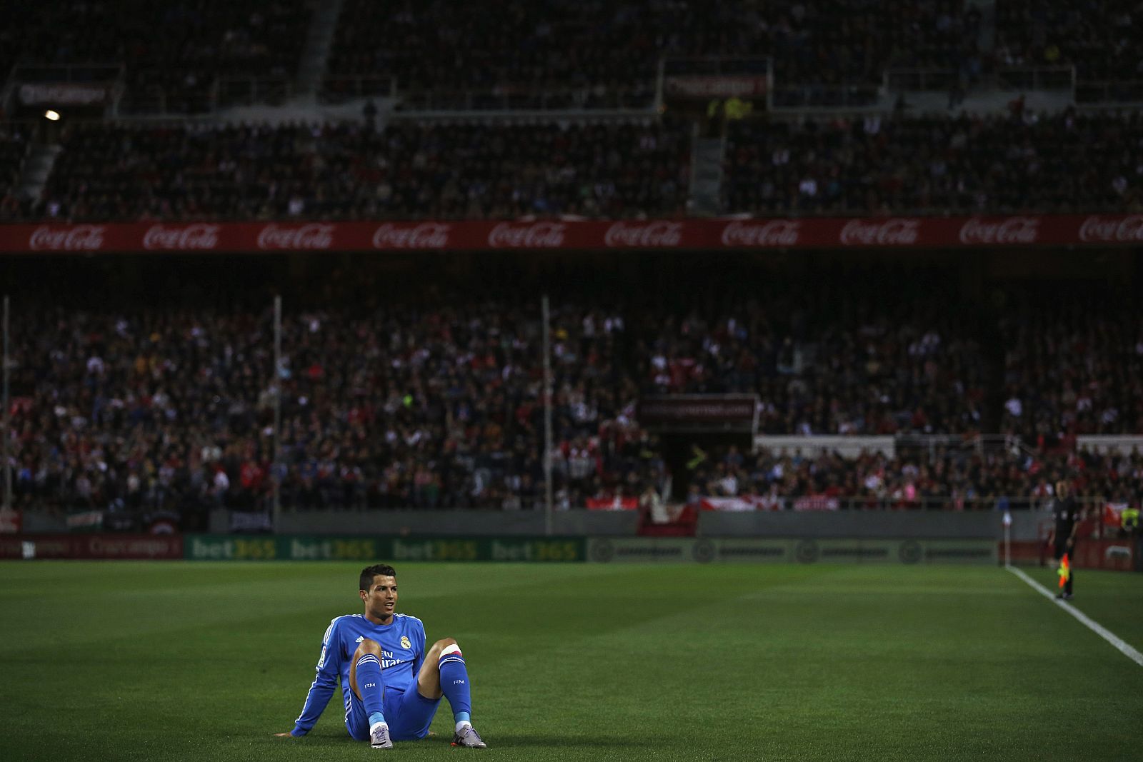 Real Madrid's Ronaldo sits on the pitch during their soccer match against Sevilla in Seville