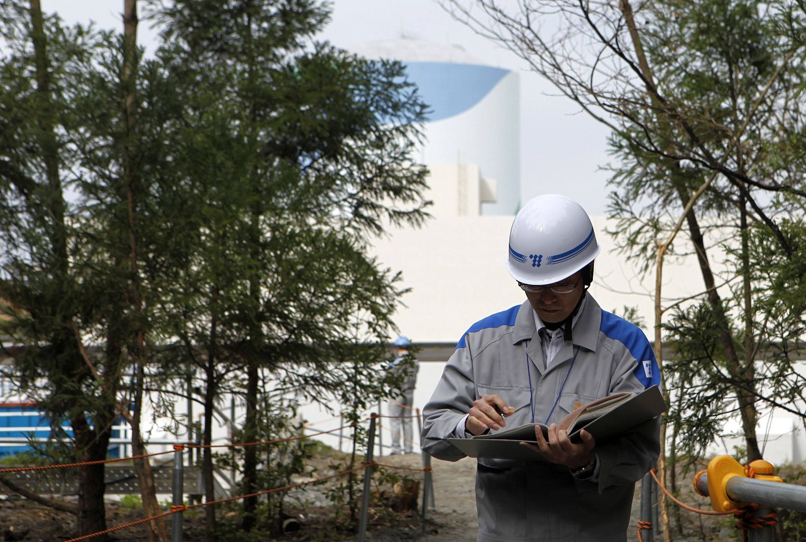 An employee of Kyushu Electric Power Co reads his memo at the company's Sendai nuclear power plant in Satsumasendai