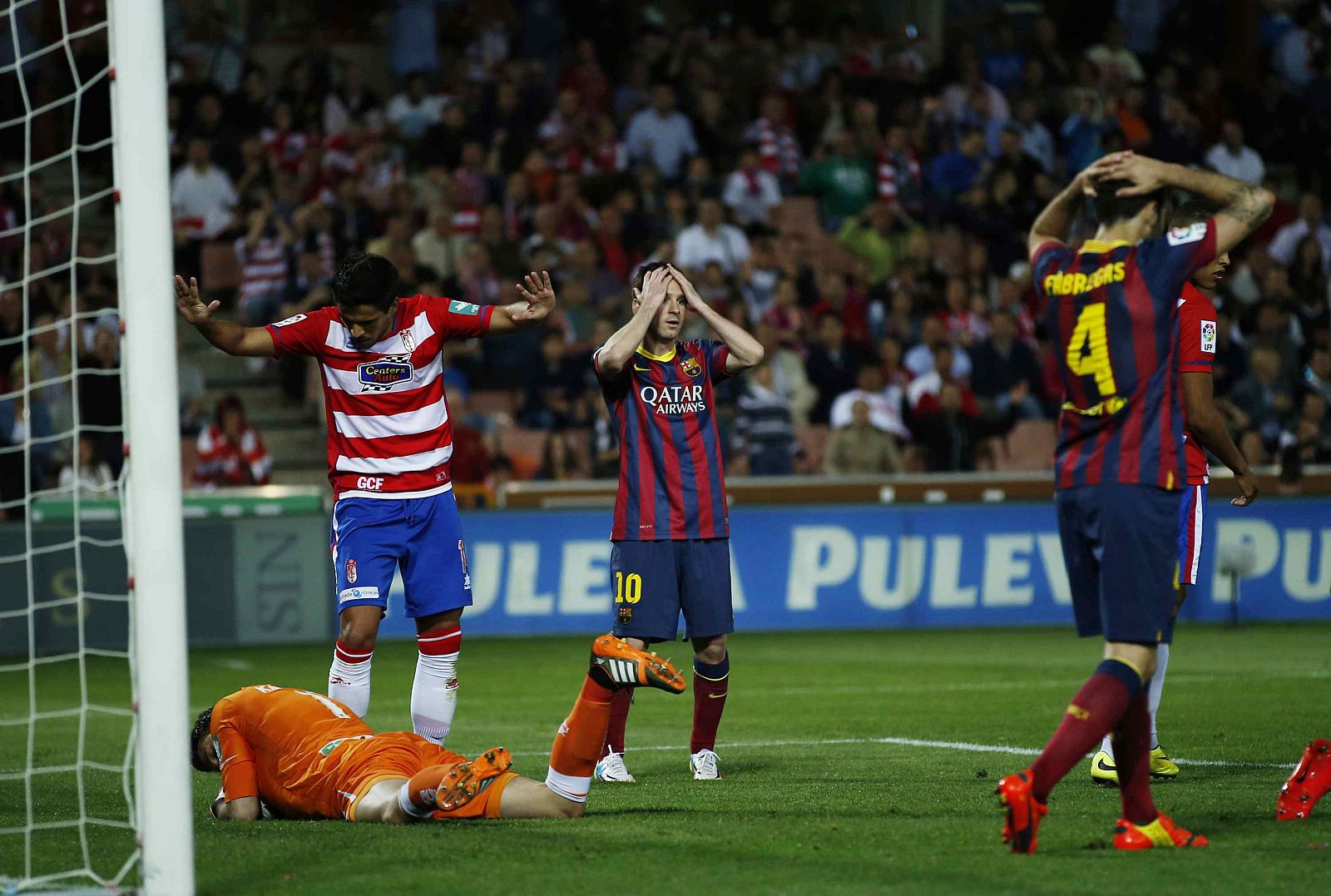 Barcelona's Messi reacts after missing a scoring opportunity during their Spanish First Division soccer match against Granada at Nuevo Los Carmenes stadium in Granada