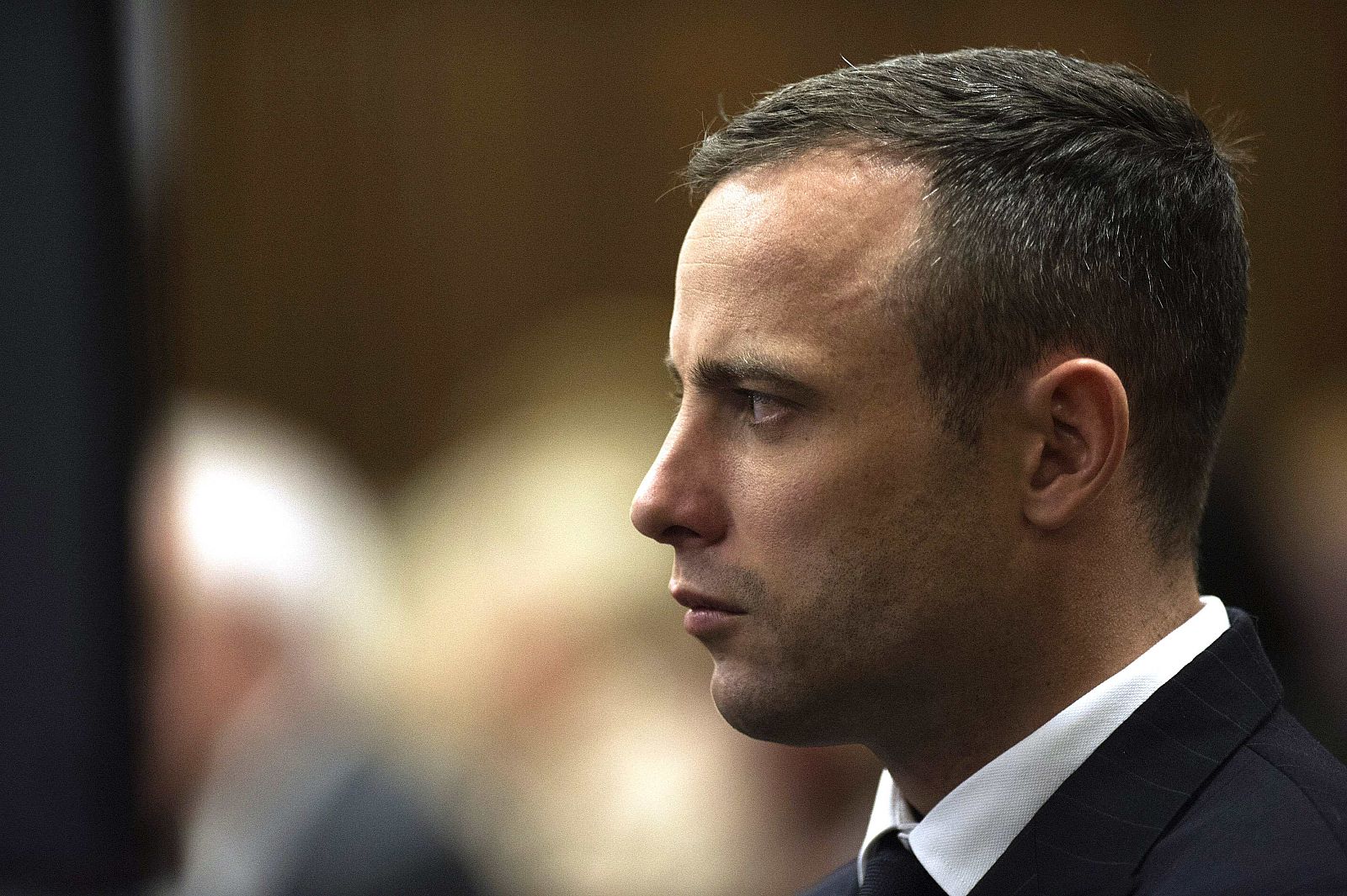 South African Olympic and Paralympic athlete Oscar Pistorius looks on during his murder trial in the North Gauteng High Court in Pretoria