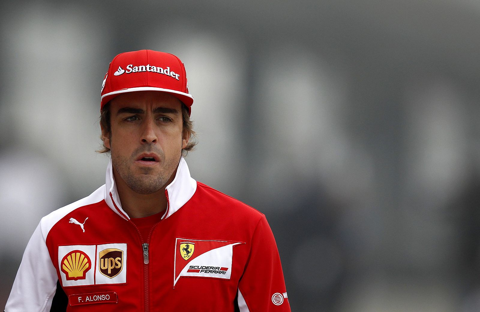 Ferrari Formula One driver Fernando Alonso of Spain arrives for a news conference ahead of the Chinese F1 Grand Prix at the Shanghai International Circuit