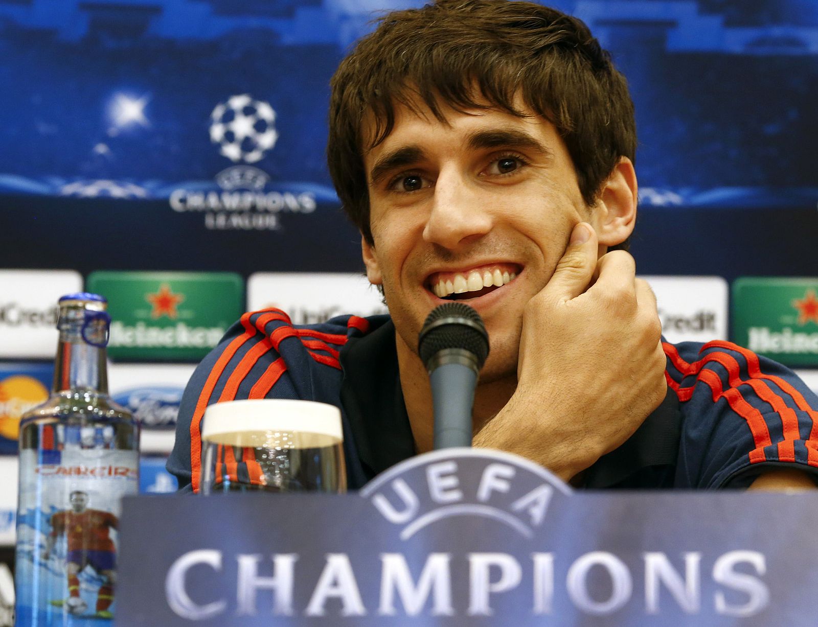 Munich's Martinez smiles during a news conference at the team hotel in Madrid