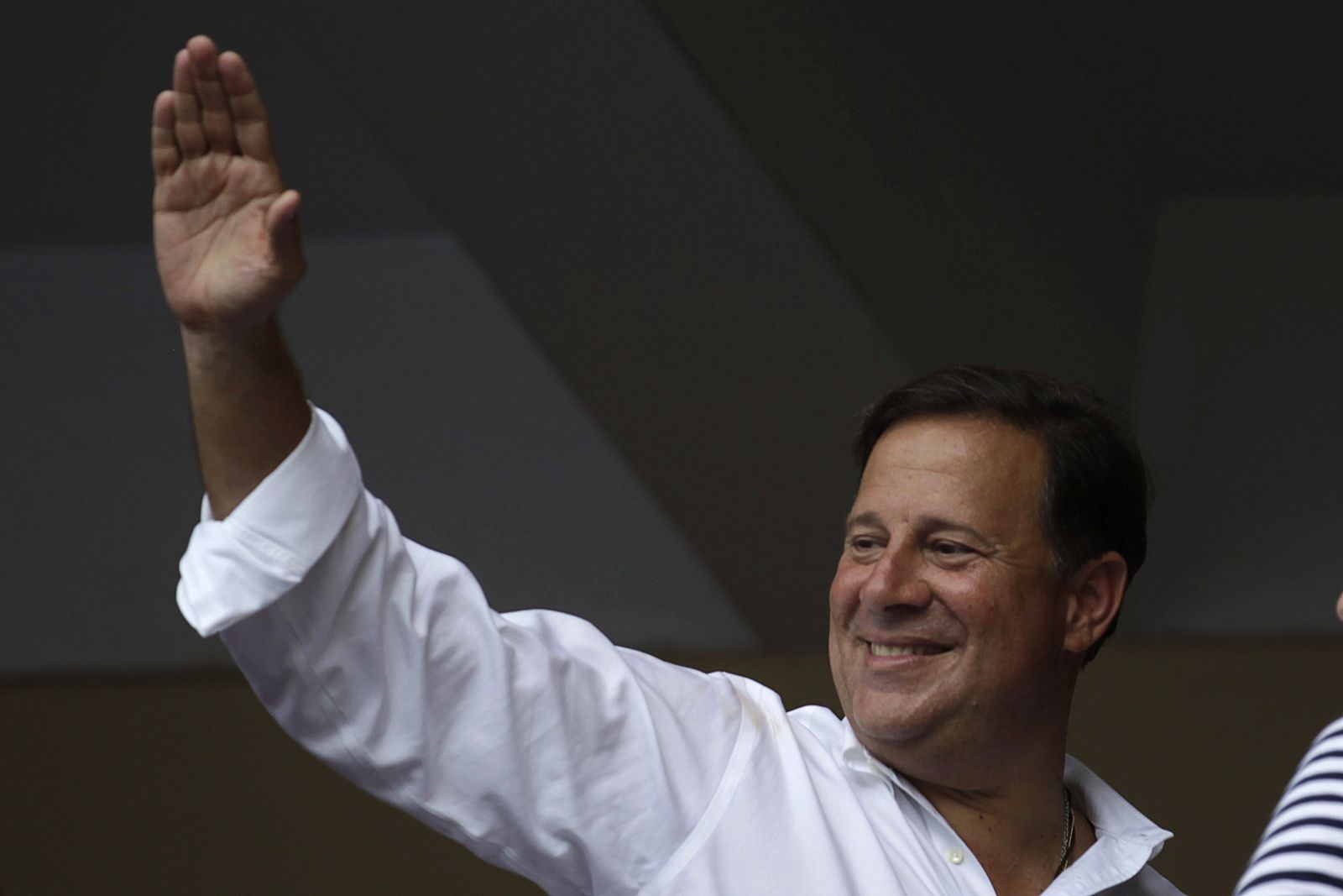 Juan Carlos Varela, presidential candidate for the Panamenista Party, waves to supporters at a polling station where his son Gian will cast his vote, in Panama City