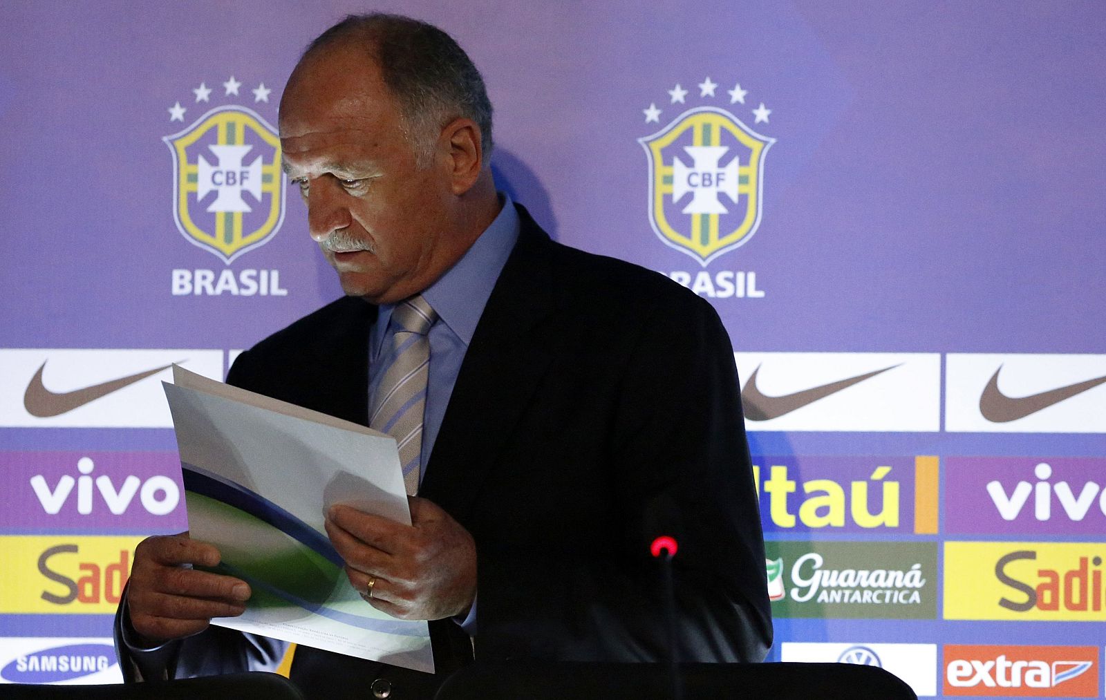 Brazilian national soccer team head coach Scolari arrives with a player list before a news conference in Rio de Janeiro