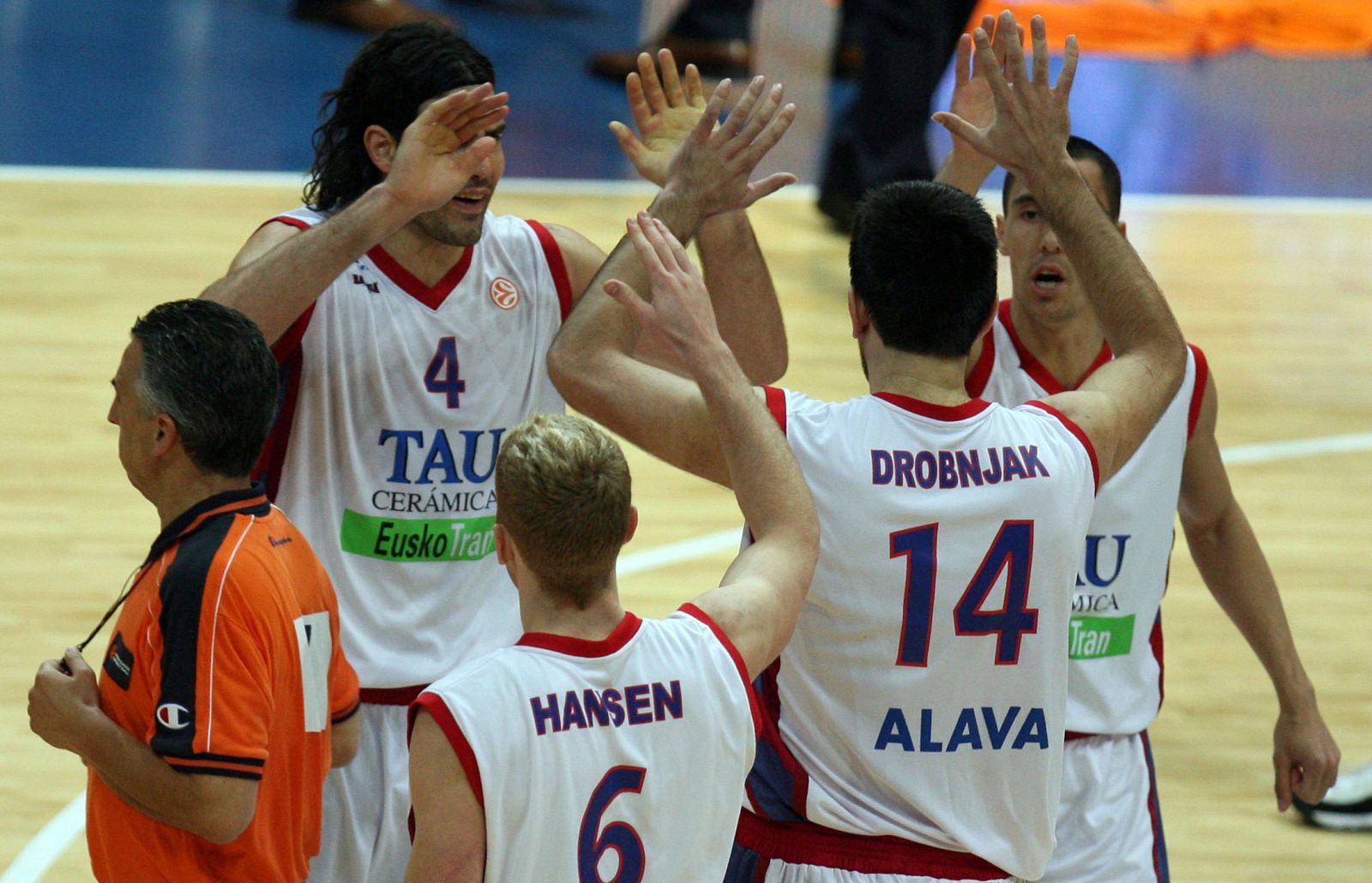 Players of Spanish team TAU Ceramica celebrate scoring in Prague