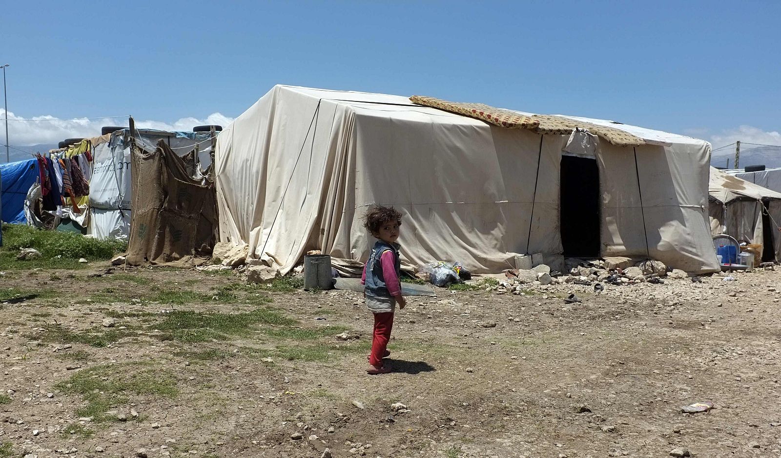 A Syrian girl stands in a refugee camp in the east Lebanese town of Anjar near the Syrian border