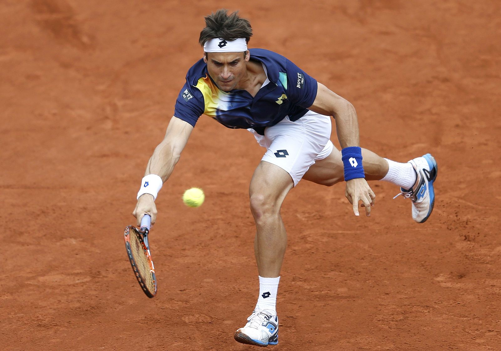 Ferrer of Spain hits a return to Sijsling of the Netherlands during their men's singles match at the French Open tennis tournament at the Roland Garros stadium in Paris