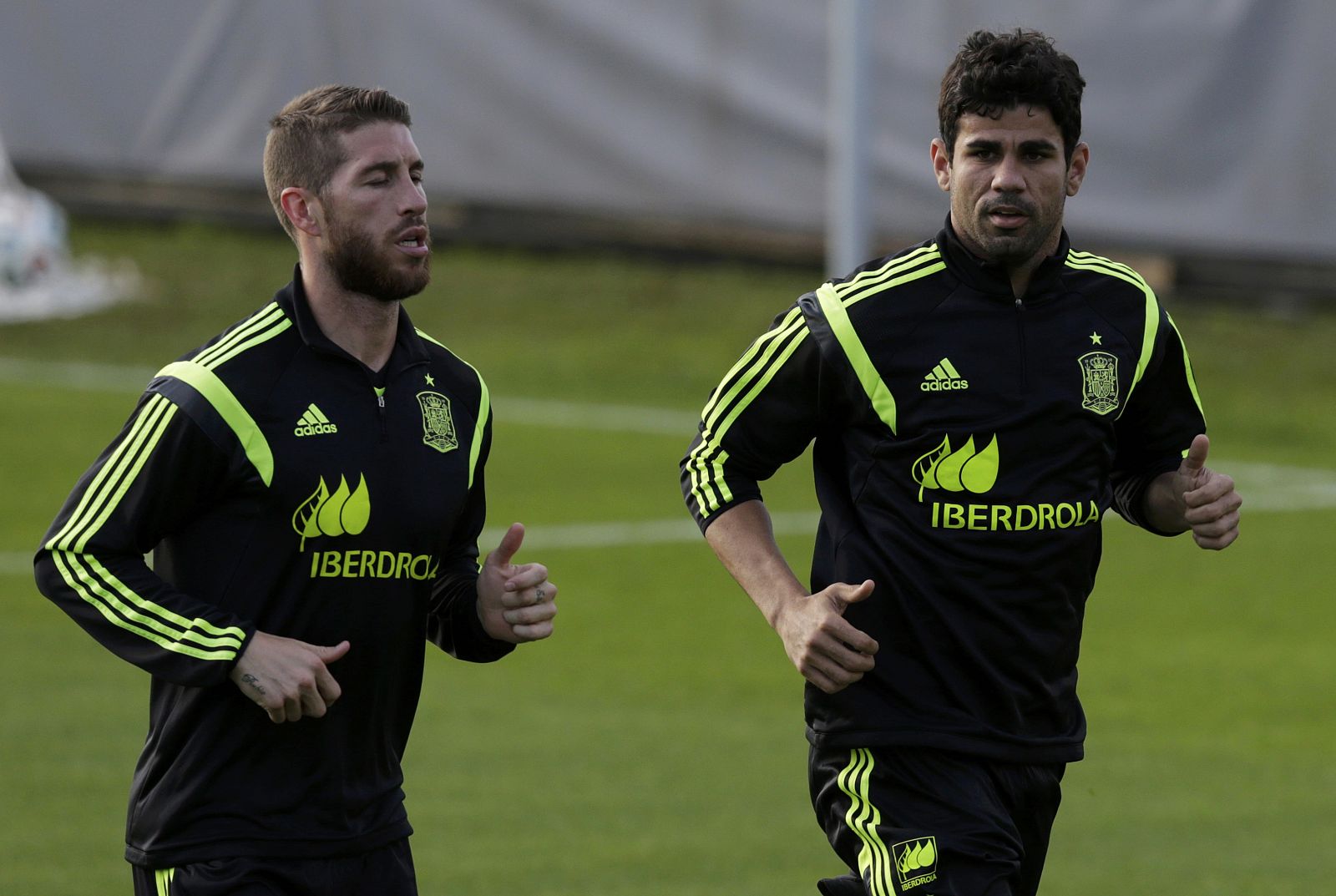 Spain's national soccer team defender Ramos runs with teammate Costa during a training session in Curitiba