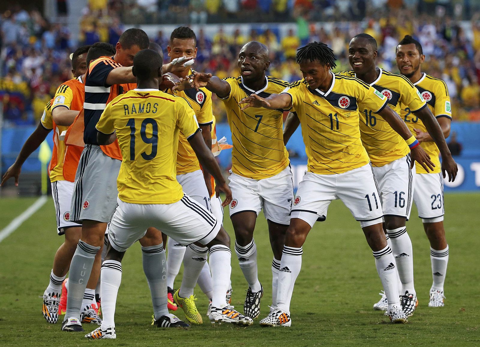 Colombia's team celebrates  Cuadrado's goal against Japan during 2014 World Cup Group C soccer match at Pantanal arena in Cuiaba