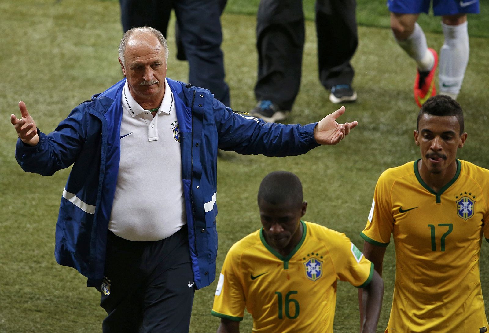 Brazil's coach Luiz Felipe Scolari gestures past Ramires and Luiz Gustavo after they lost their 2014 World Cup semi-finals against Germany at the Mineirao stadium in Belo Horizonte