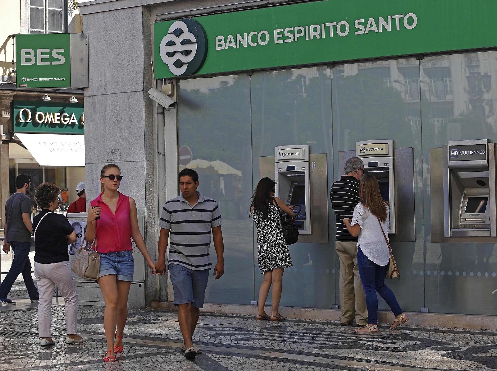 People walk past an office of Portuguese bank Banco Espirito Santo in downtown Lisbon