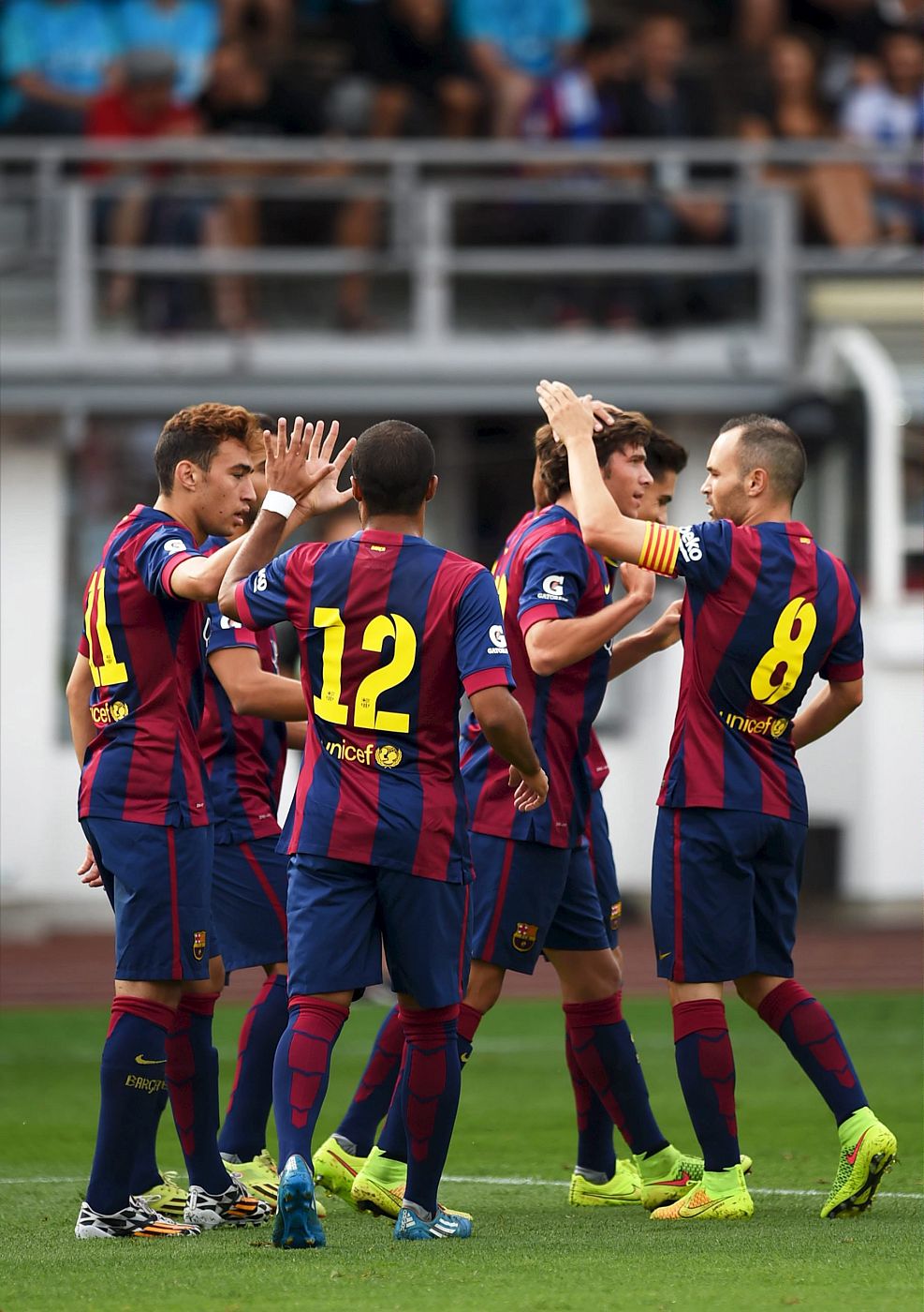 Barcelona's players celebrating a goal against HJK during their friendly soccer match in Helsinki