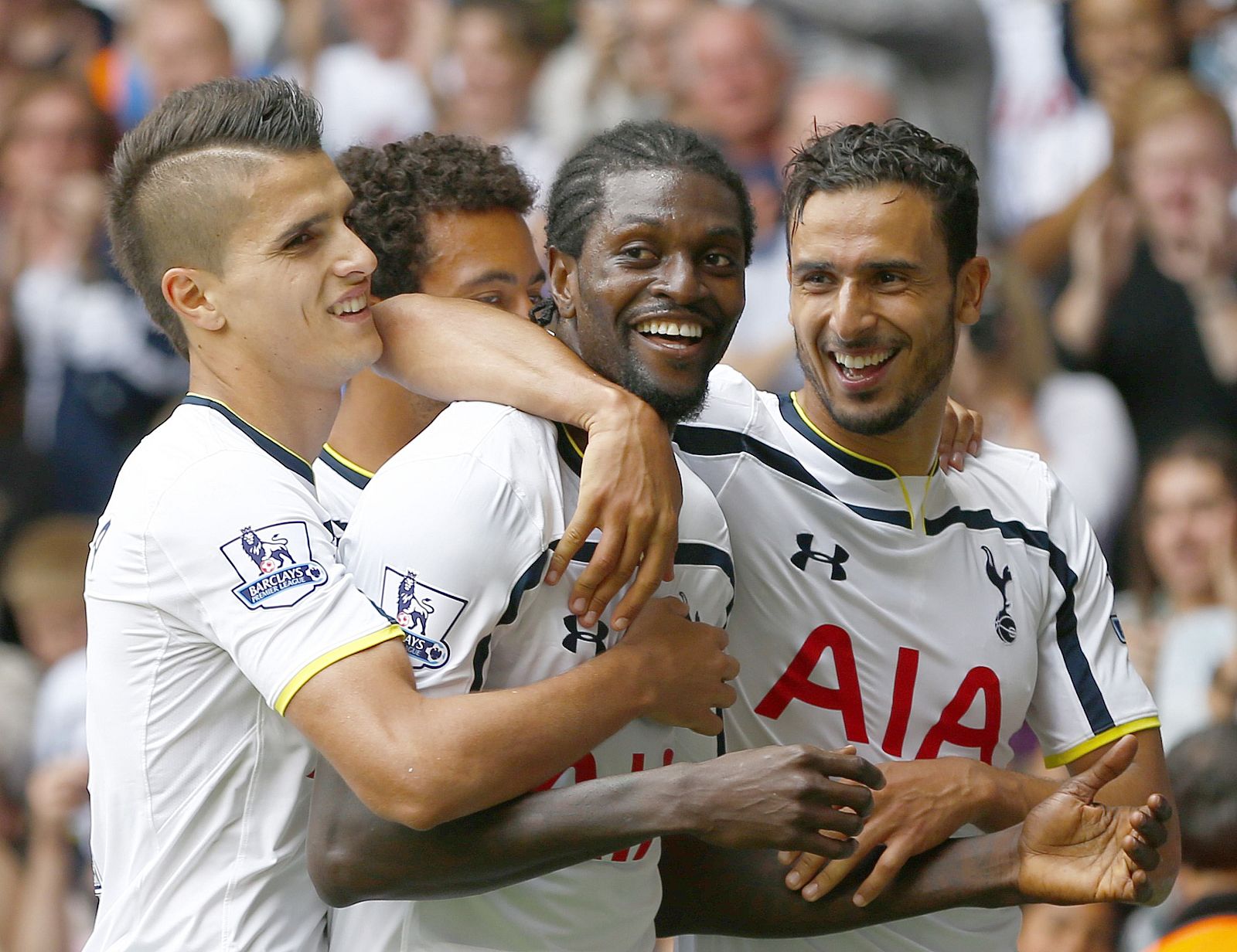 Tottenham Hotspur's Adebayor celebrates with team mates after scoring a goal against Queens Park Rangers during their English Premier League soccer match at White Hart Lane in London